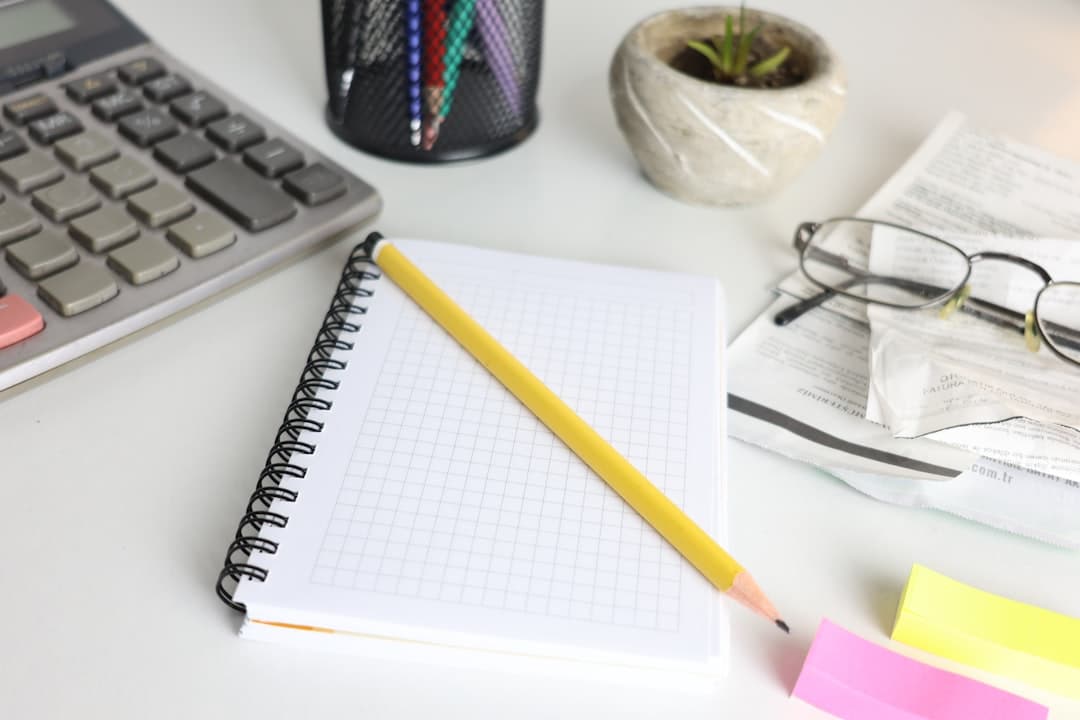 An invoice and calculator on a small business owner's desk.