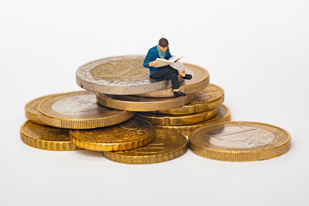 UK pound coins next to a small business ledger.