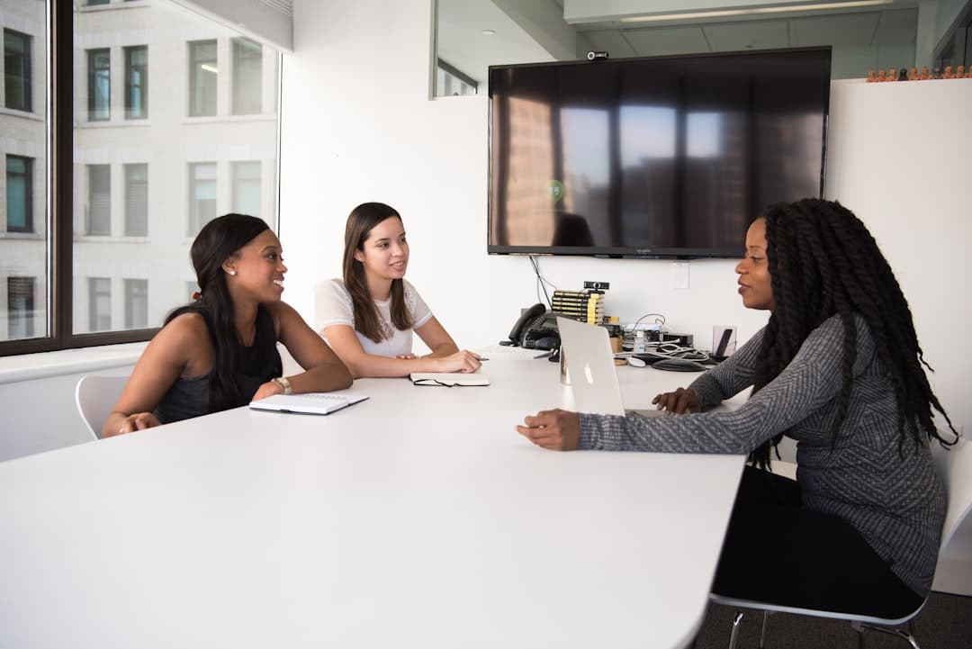 Two people in a hiring conversation across a desk.